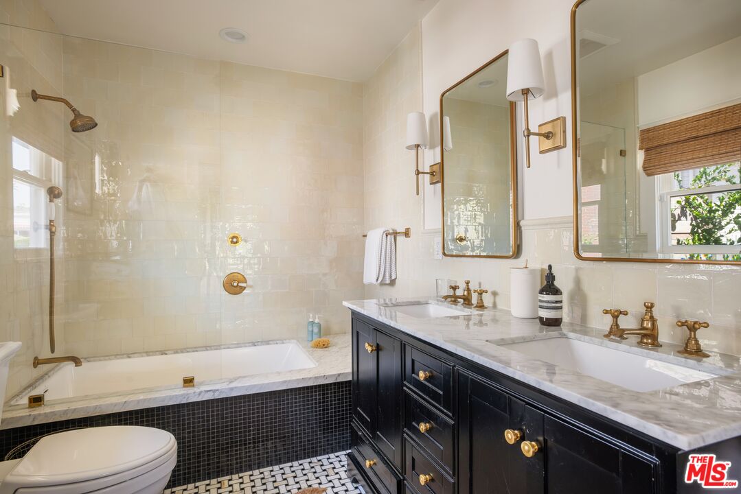 5152 Vincent Avenue Los Angeles, CA 90041 - Photo 29 of 36 a bathroom with a granite countertop bathtub sink vanity mirror and toilet