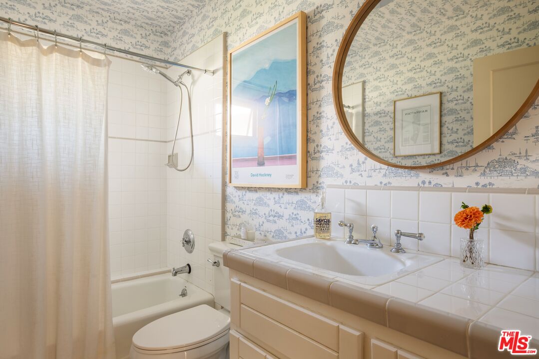 5152 Vincent Avenue Los Angeles, CA 90041 - Photo 34 of 36 a bathroom with a sink a toilet and a mirror