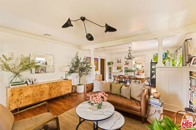 a living room with furniture and kitchen view