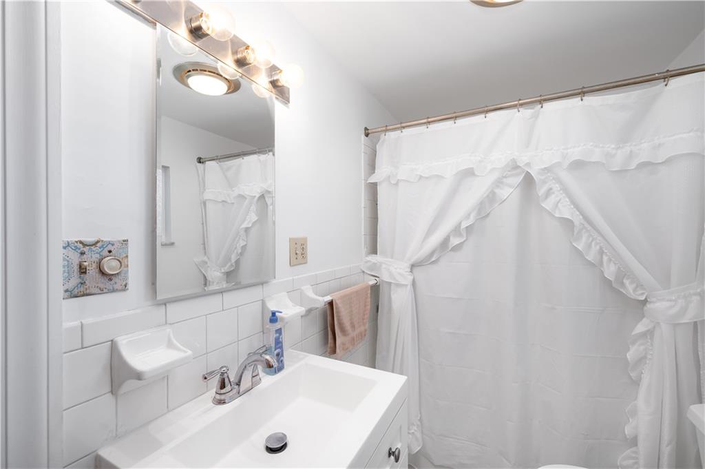 411 Harmony Road Baden, PA 15005 - Photo 18 of 25 a bathroom with a sink and a mirror