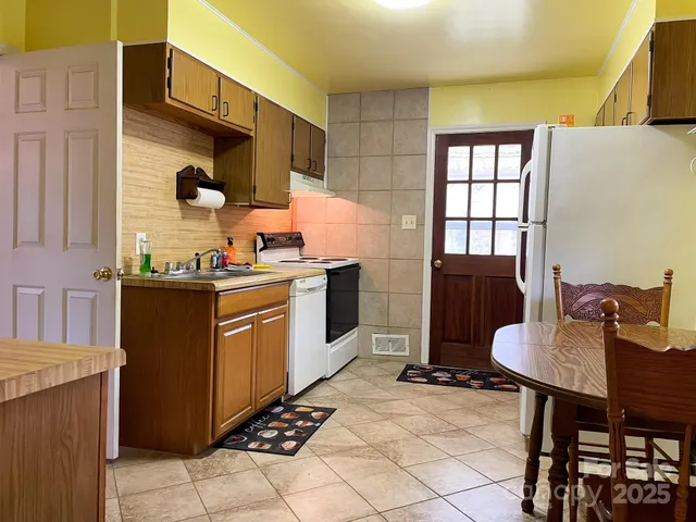 a kitchen with a sink cabinets and window
