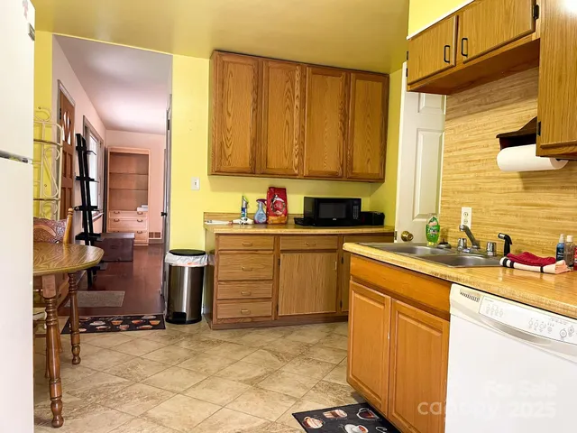 a kitchen with a sink cabinets and window