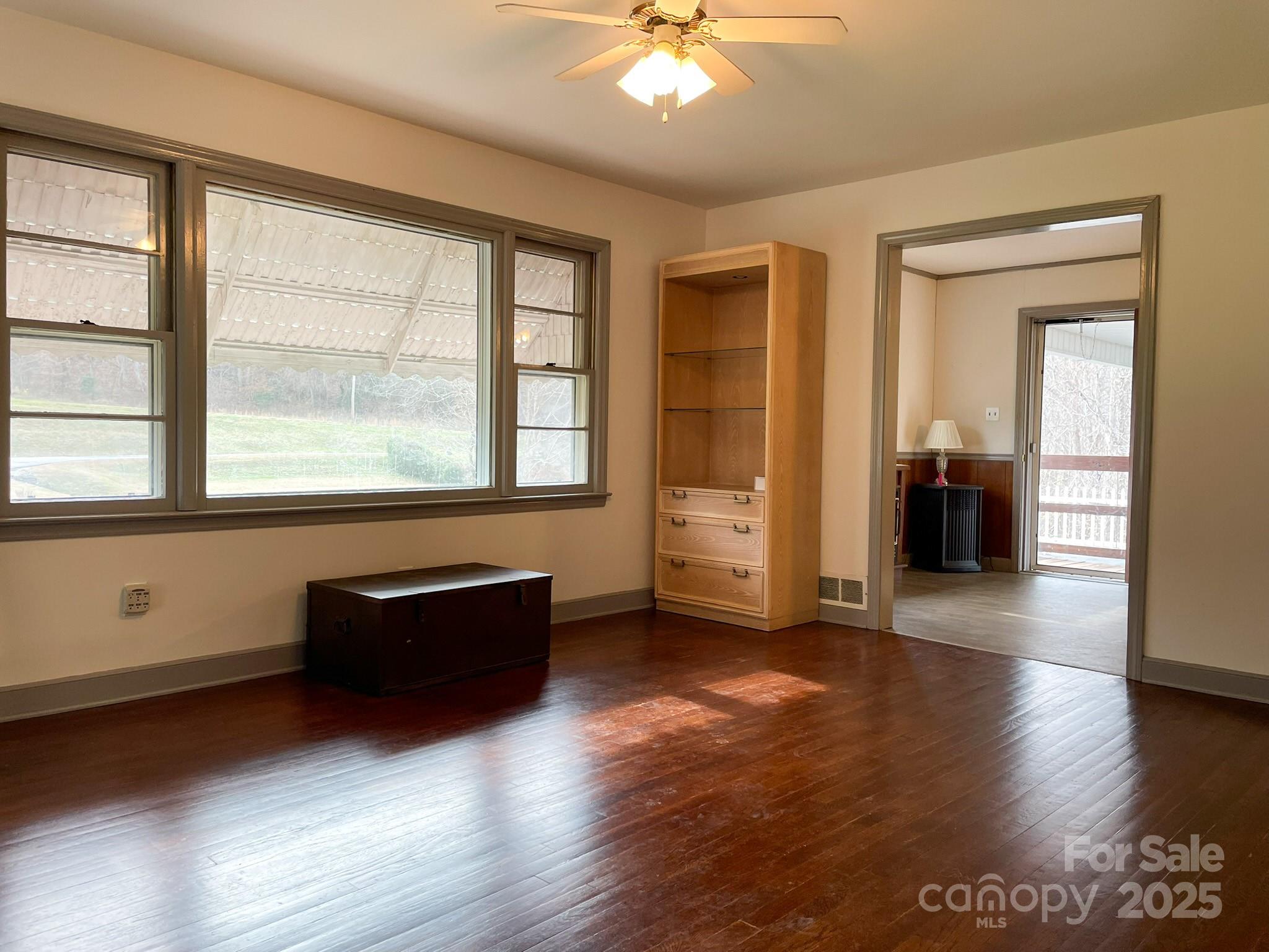 3799 Highway 18 Morganton, NC 28655 - Photo 8 of 33 an empty room with wooden floor and windows
