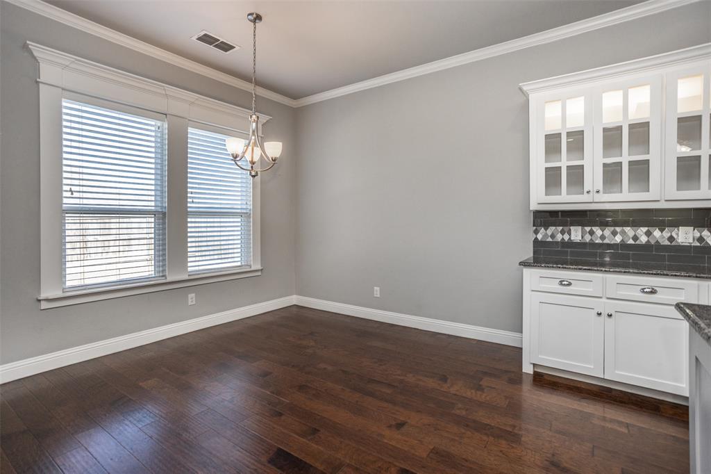 702 La Paloma Road Sanger, TX 76266 - Photo 11 of 40 a view of an empty room with a window and wooden floor