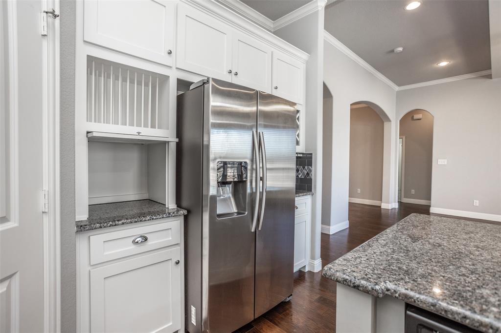702 La Paloma Road Sanger, TX 76266 - Photo 14 of 40 a kitchen with stainless steel appliances granite countertop a refrigerator and a sink