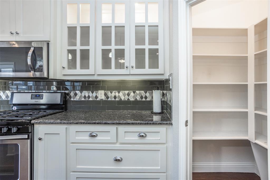 702 La Paloma Road Sanger, TX 76266 - Photo 15 of 40 a view of kitchen with granite countertop a stove and a microwave