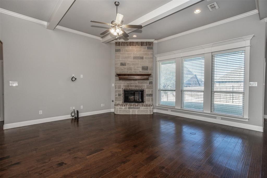 702 La Paloma Road Sanger, TX 76266 - Photo 18 of 40 a view of an empty room with wooden floor and a window