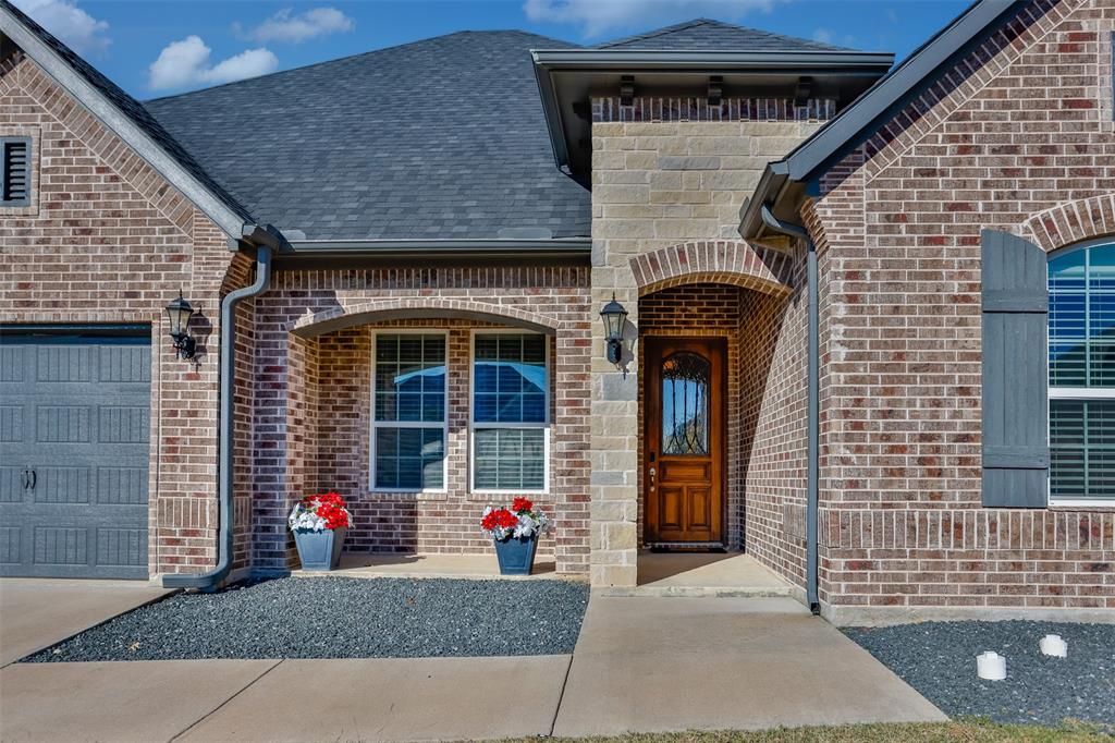 702 La Paloma Road Sanger, TX 76266 - Photo 2 of 40 a front view of a house with entryway