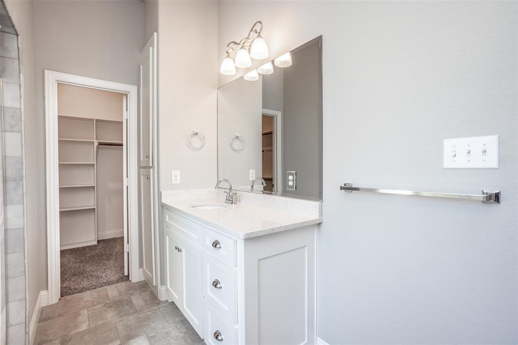 702 La Paloma Road Sanger, TX 76266 - Photo 25 of 40 a bathroom with a sink vanity and a mirror