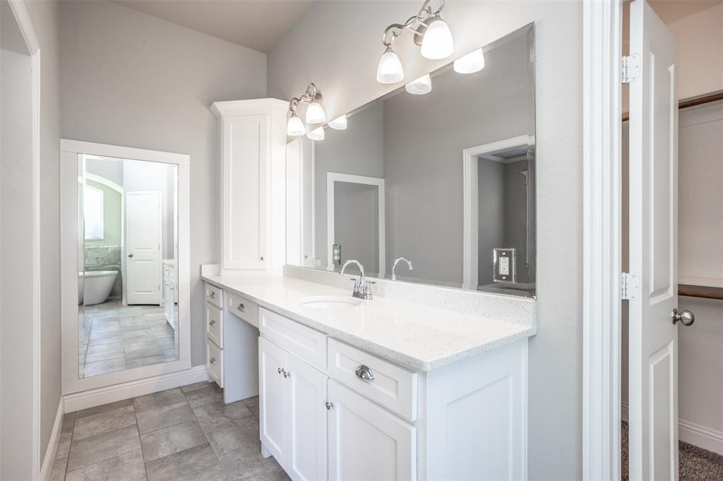 702 La Paloma Road Sanger, TX 76266 - Photo 26 of 40 a bathroom with a sink a mirror and a shower