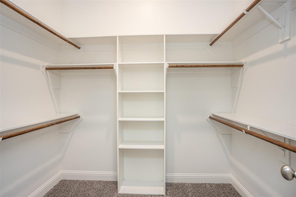 702 La Paloma Road Sanger, TX 76266 - Photo 27 of 40 a view of walk in closet with empty racks