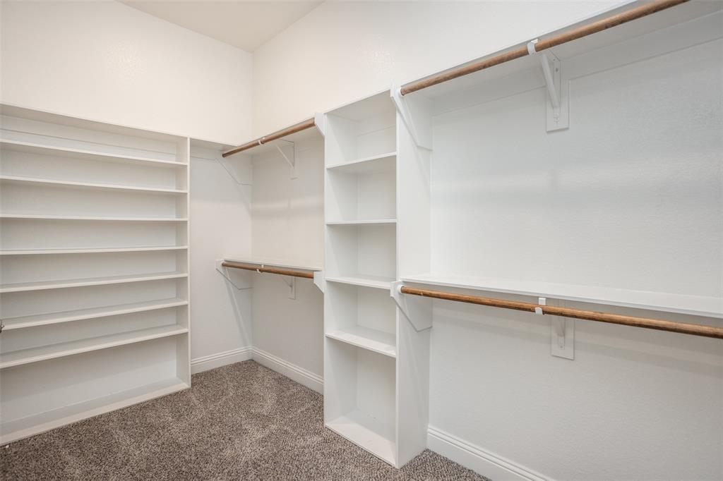 702 La Paloma Road Sanger, TX 76266 - Photo 28 of 40 a view of walk in closet with empty racks