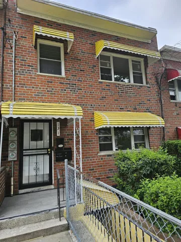 a view of a brick house with large windows