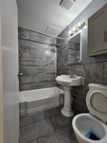 a bathroom with a sink a toilet and bathtub