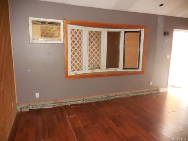 2 Hollow Street Bellport, NY 11713 - Photo 14 of 29 a view of an empty room with wooden floor and a window