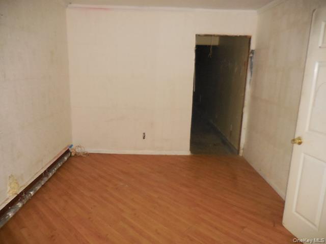 2 Hollow Street Bellport, NY 11713 - Photo 18 of 29 an empty room with wooden floor and windows