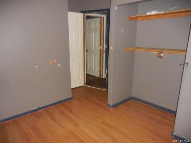 2 Hollow Street Bellport, NY 11713 - Photo 28 of 29 an empty room with wooden floor and entrance