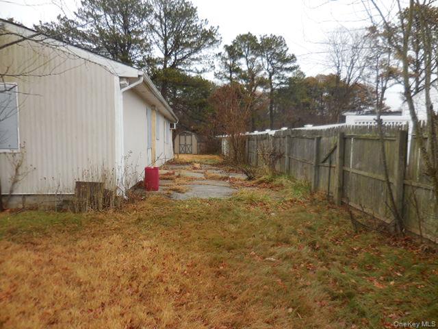 2 Hollow Street Bellport, NY 11713 - Photo 4 of 29 a backyard of a house with table and chairs