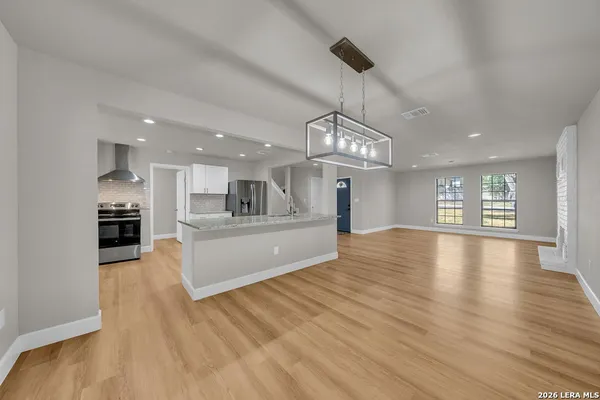 a view of a kitchen with a sink and a floor to ceiling window