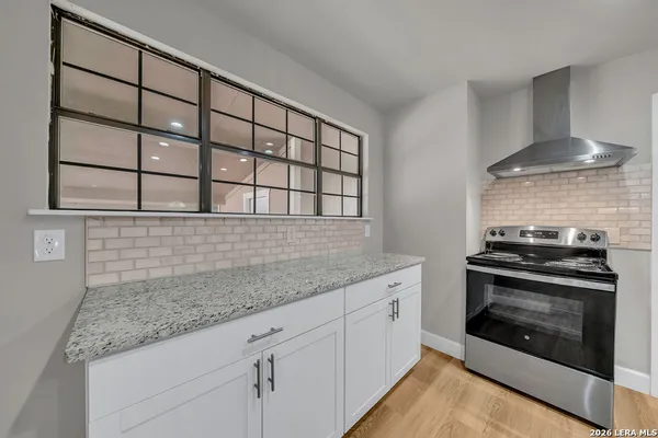 a kitchen with stainless steel appliances granite countertop a stove and a sink