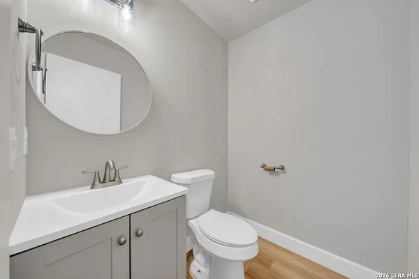 a bathroom with a toilet a sink and mirror