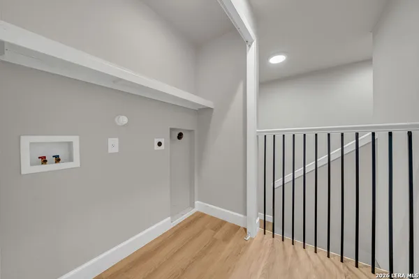 a view of a hallway with wooden floor