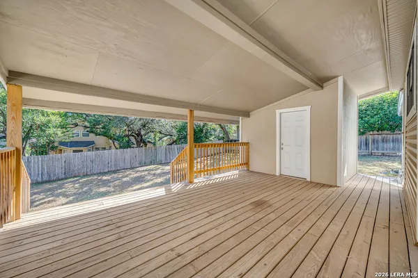 a view of backyard with a wooden deck
