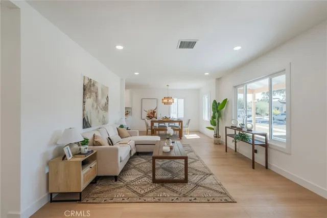 a living room with hard wood flooring and furniture