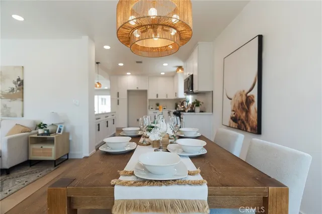 a kitchen with white cabinets and sink