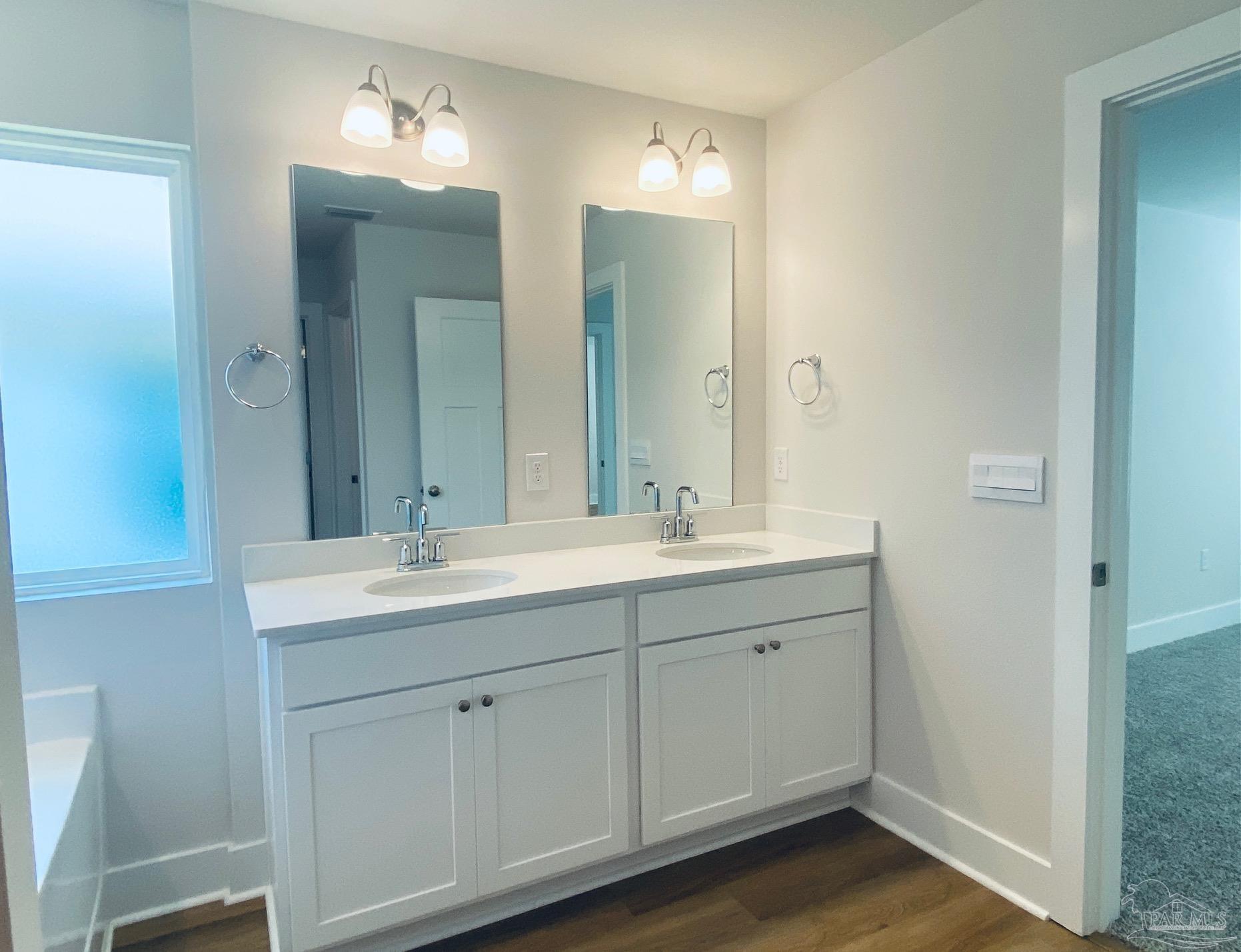 3021 Serviceberry Road Cantonment, FL 32533 - Photo 10 of 21 a bathroom with a double vanity sink and a mirror
