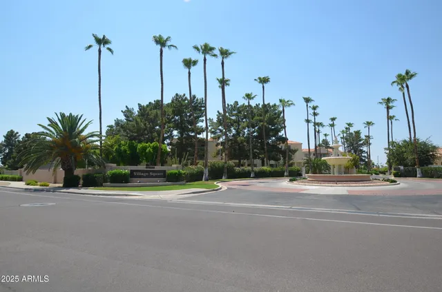 a house with a yard and palm trees