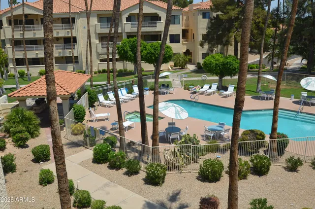 a view of a patio with table and chairs potted plants