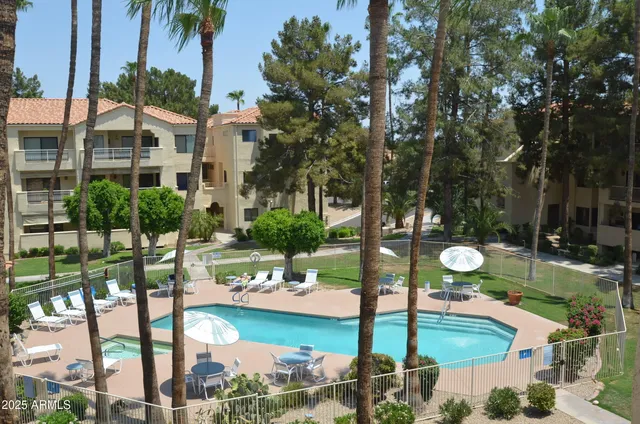 a view of a water fountain in a backyard