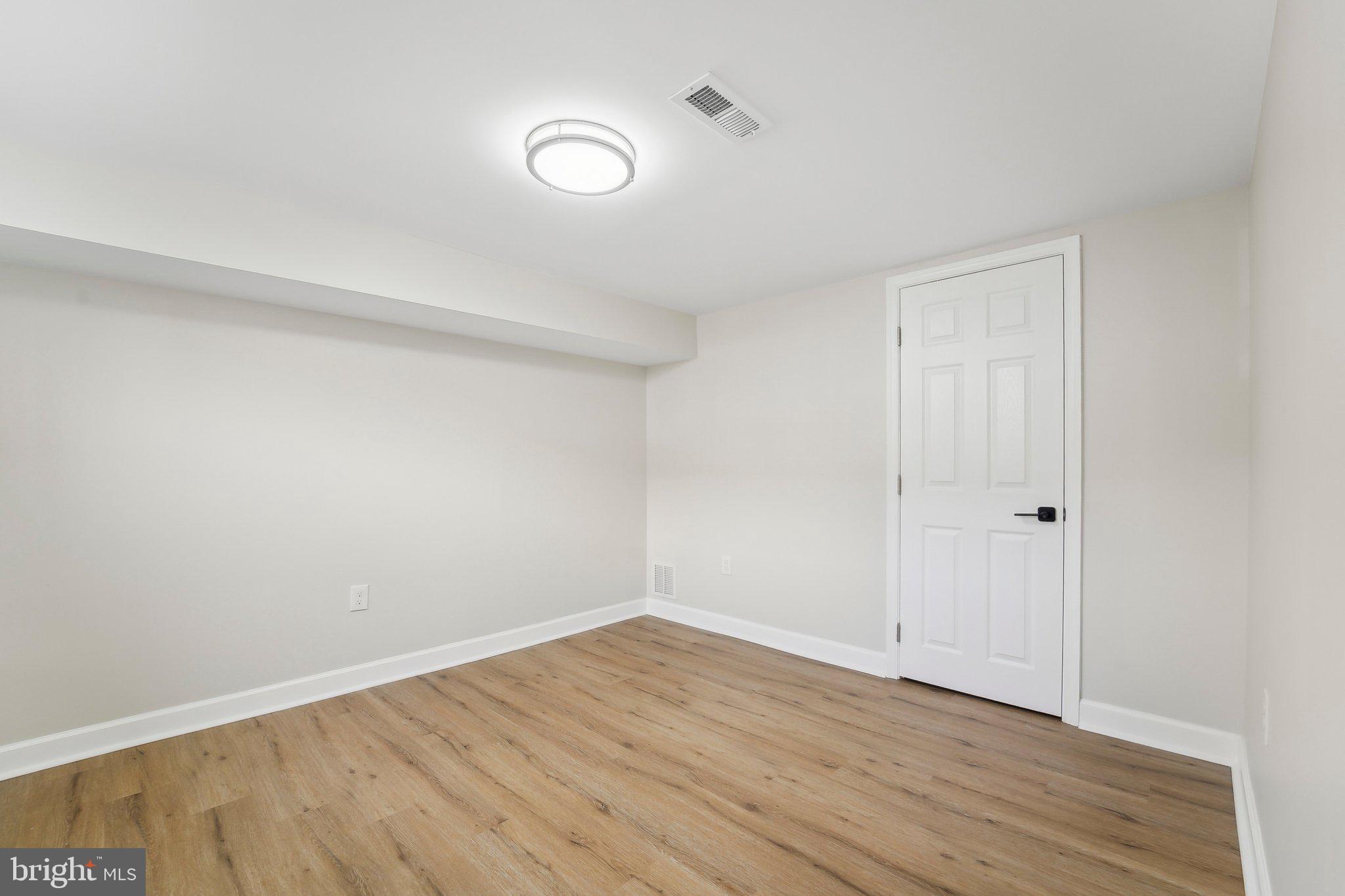 2920 Cornwall Road Dundalk, MD 21222 - Photo 13 of 38 a view of an empty room with wooden floor and a window