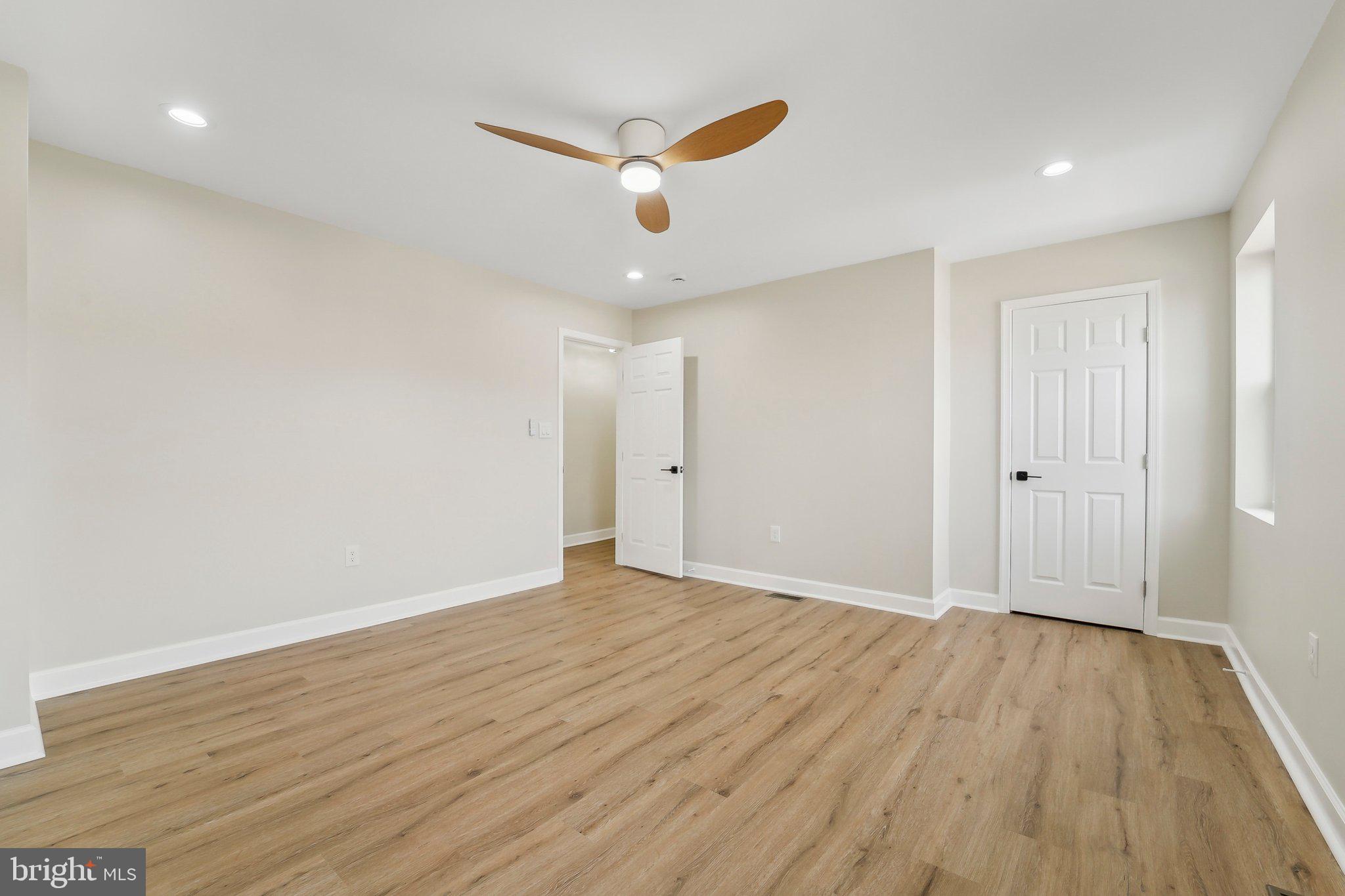 2920 Cornwall Road Dundalk, MD 21222 - Photo 30 of 38 a view of an empty room with wooden floor and a ceiling fan