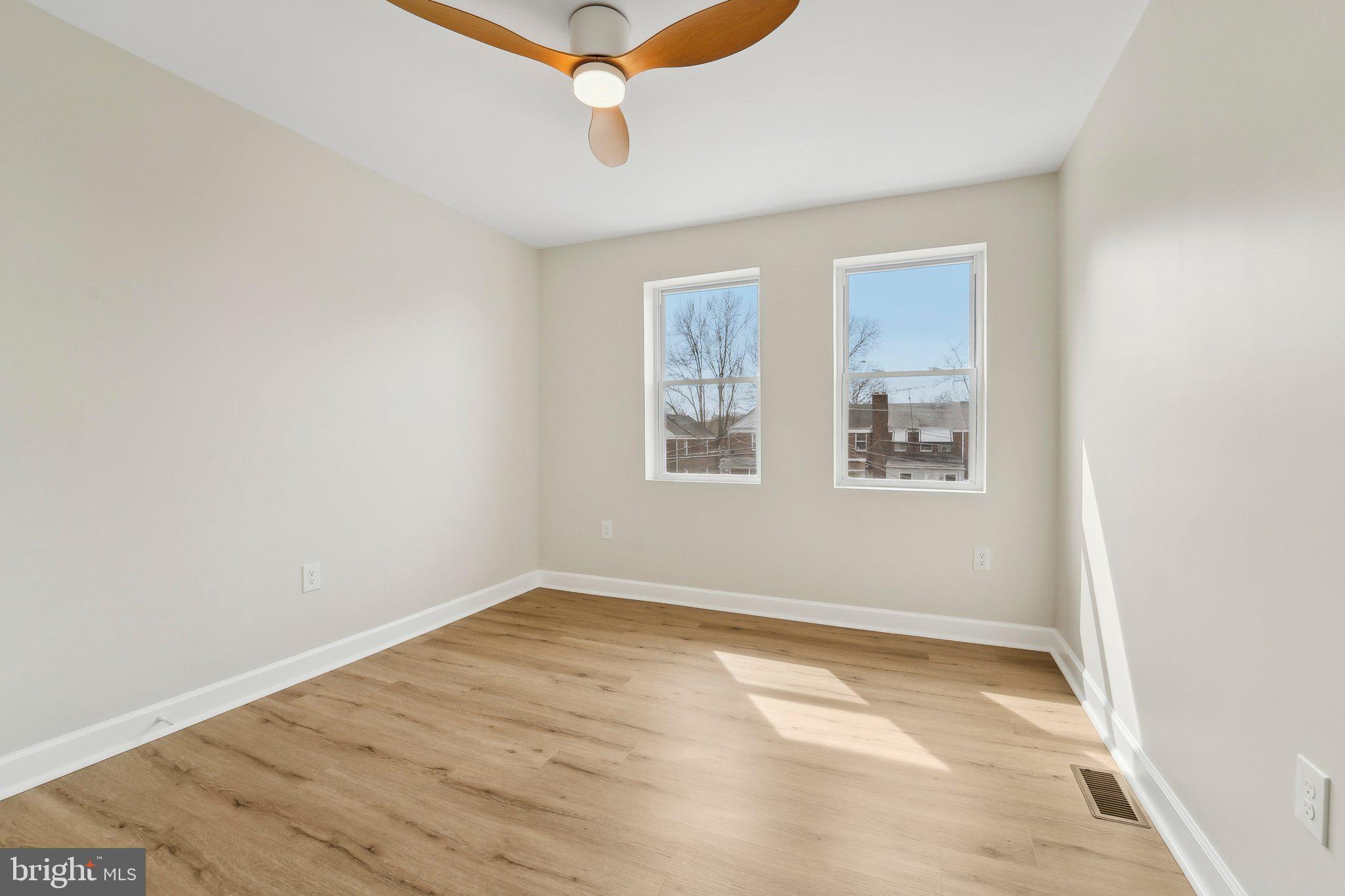 2920 Cornwall Road Dundalk, MD 21222 - Photo 32 of 38 an empty room with wooden floor and windows