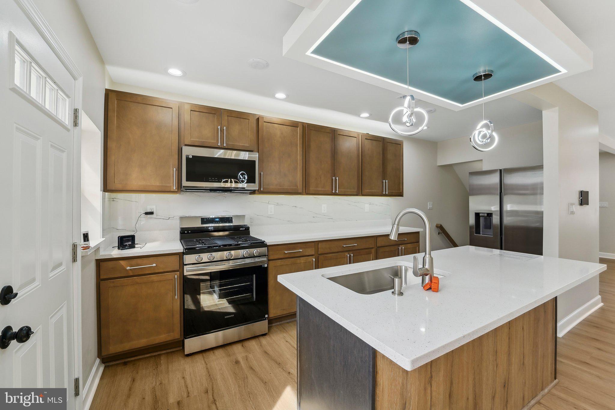 2920 Cornwall Road Dundalk, MD 21222 - Photo 6 of 38 a kitchen with granite countertop a sink a counter top space appliances and cabinets