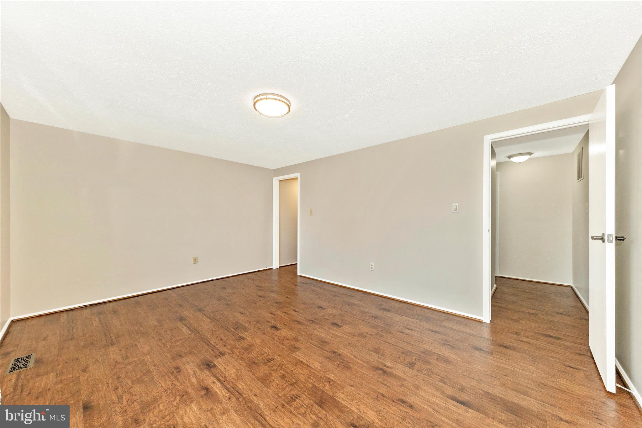 6616 Pebble Court Frederick, MD 21703 - Photo 16 of 33 an empty room with wooden floor and windows