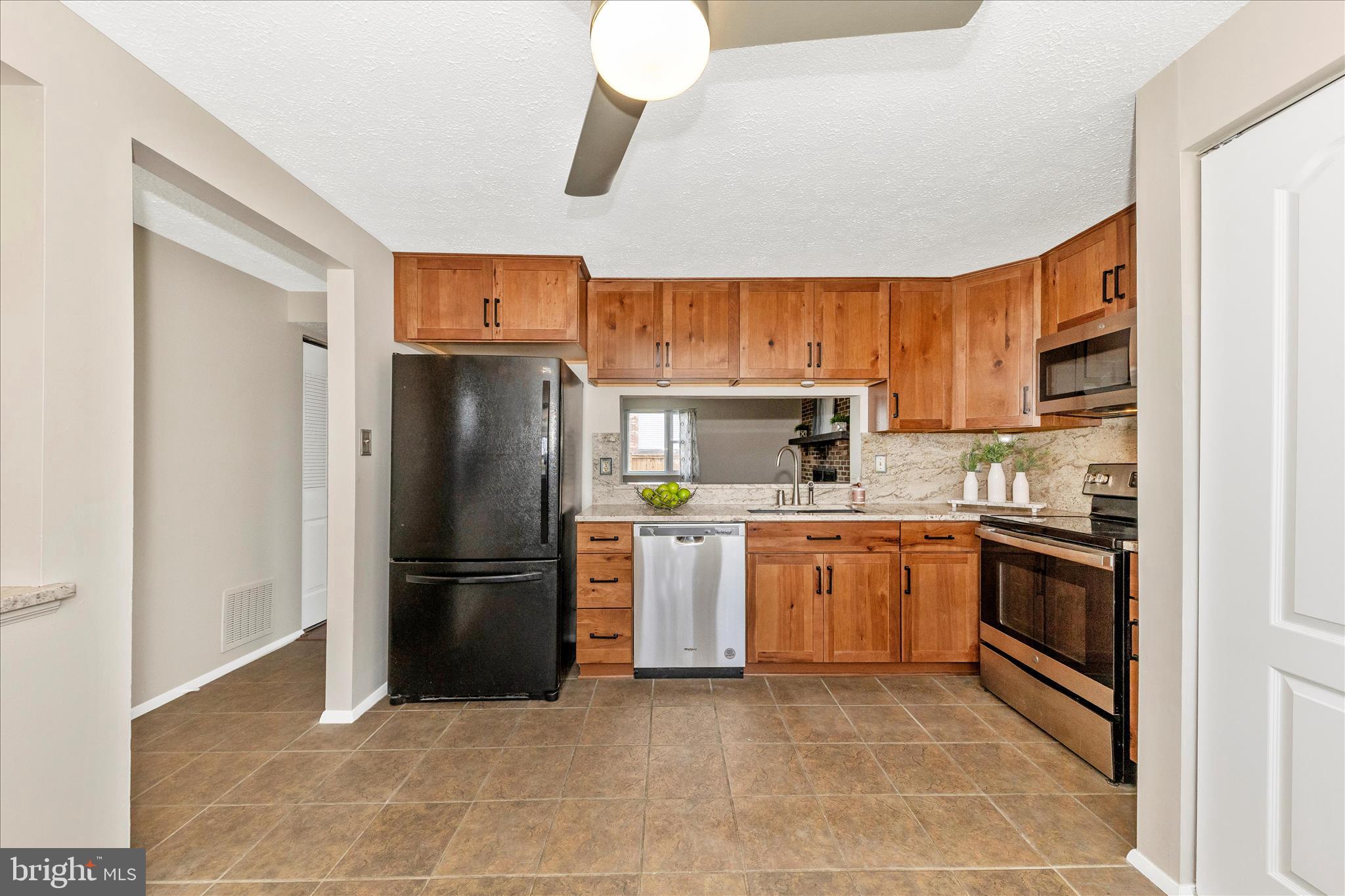 6616 Pebble Court Frederick, MD 21703 - Photo 5 of 33 a kitchen with a refrigerator and a sink