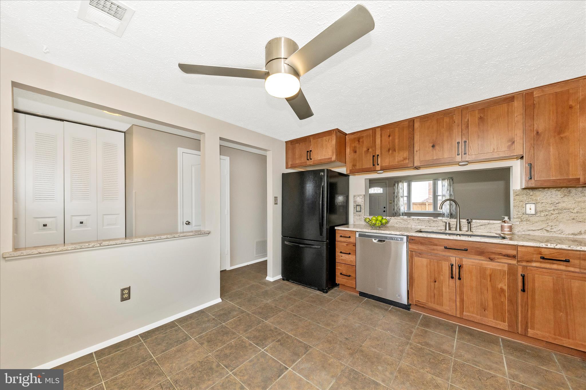 6616 Pebble Court Frederick, MD 21703 - Photo 6 of 33 a kitchen with a sink and refrigerator