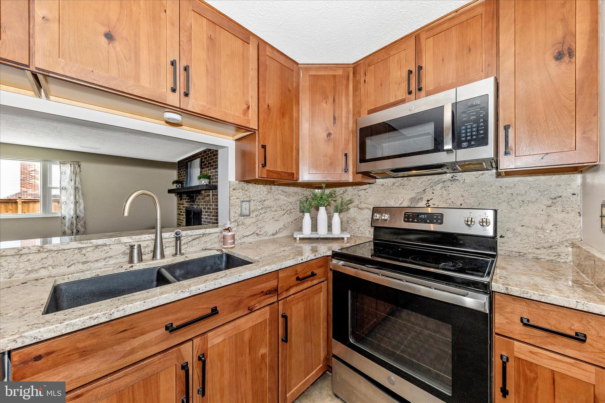 6616 Pebble Court Frederick, MD 21703 - Photo 7 of 33 a kitchen with stainless steel appliances a stove microwave and sink