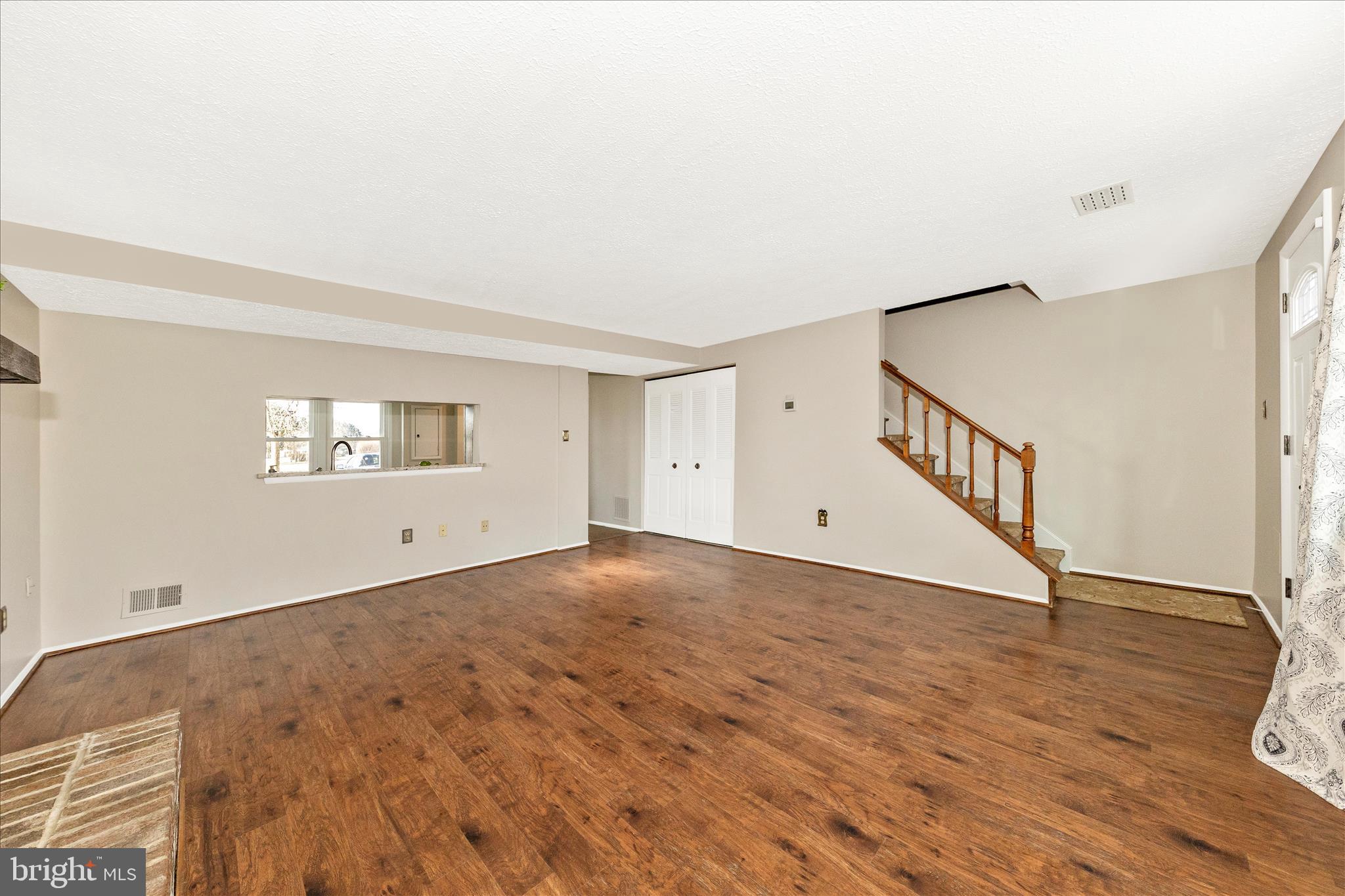 6616 Pebble Court Frederick, MD 21703 - Photo 10 of 33 a view of an empty room with wooden floor and a window
