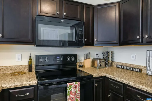 a kitchen with granite countertop a stove and a sink