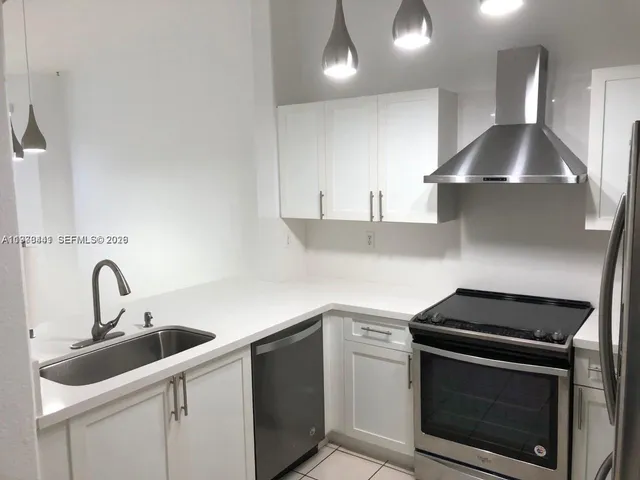 a kitchen with a stove microwave and sink