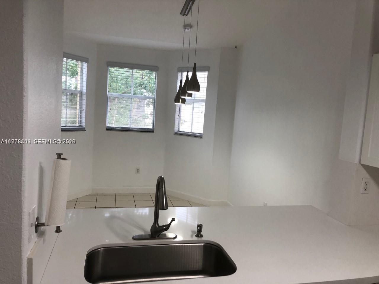 2925 Southeast 16th Avenue, Unit 202 Homestead, FL 33035 - Photo 3 of 11 a sink with a window