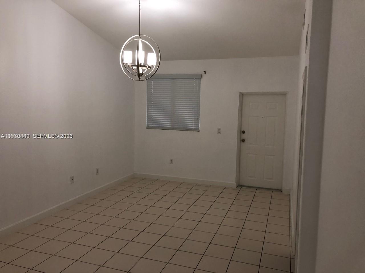 2925 Southeast 16th Avenue, Unit 202 Homestead, FL 33035 - Photo 5 of 11 a view of a room with racks on the wall