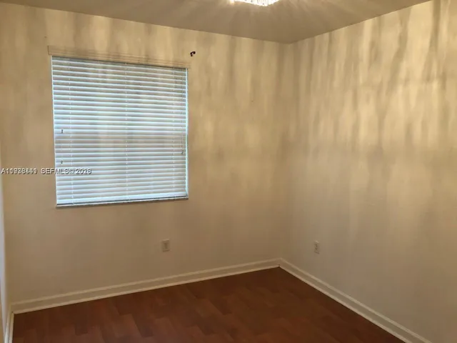 a view of a small space with a window and a fan