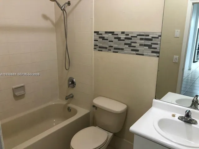 a bathroom with a toilet sink and shower