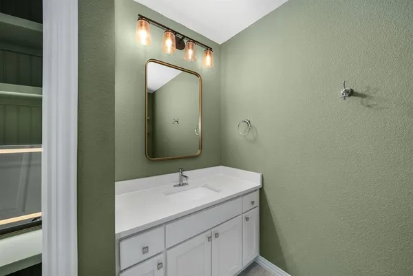 a bathroom with a sink and mirror