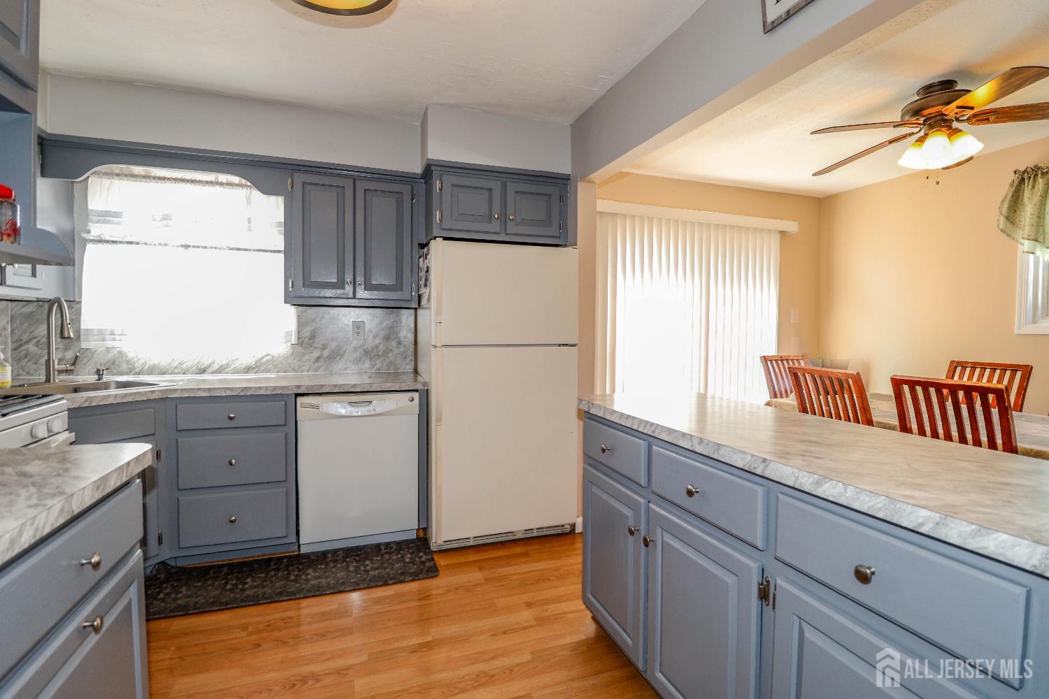 26 Moryan Road Edison, NJ 08817 - Photo 12 of 32 a kitchen with a refrigerator sink and cabinets